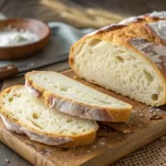Gluten free Italian bread loaf sliced on wooden board